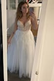 This is truly a stunning dress. I immediately fell in love with it. The top however isn't the comfiest. The straps are made out of a stiff tulle and with the weight of the dress they are digging into my shoulders. Also, the dress rubs under my arm in the back towards my shoulder blade. I think if I had smaller breasts this wouldn't be an issue. They're not really a lot of room for the girls in this dress. Debating keeping it but I would definitely need alterations in the top. - Jasmine H.