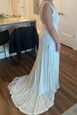 Overall it's a beautiful dress! I wish the fit at the top was tighter for better support since it is difficult to find a great no show bras for a larger chest. I am not wearing heels in the photo. I wouldn't get it tailored since the beads are so beautiful. - Michaela G.