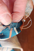 I loved this dress, the fit, and pattern are BEAUTIFUL but when I pulled it out of the packaging I immediately noticed fraying threads ..... see pictures. I will be requesting an exchange and hope the next one is not damaged. - Mindy K.