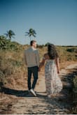 Loved this dress for our photos! No issues with it staying in place. The wind caught it weird in some pictures, but I think that was more of an issue with when the photo was snapped than the dress. Very fun and flowy! - Danielle D.