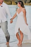 I wore this for my 10-year vow renewal in the Bahamas. Ordered an XS based on people with my similar build (5'2, 34D bust, and pretty curvy in my hips/butt). I didn't get it taken in because I knew we'd be on the beach. It flowed perfectly and fit amazing! It was a bit sheer on the bust so I recommend pasties/nipple covers if getting white. Loved the high/low cut and the slit in the front. It's pretty long, so if I were at any other event I would probably get it hemmed a bit in the back. - Vanessa B.