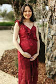 I got this dress for a photoshoot. I was 7 months pregnant and got a size medium and it fit fairly well. I'm normally an XS in Lulus dresses. It was a little tight in the belly area but that had nothing to do with the dress, rather than my growing belly. It's a beautiful dress but it made me look like I was going salsa dancing lol. Other than that it was a pretty dress. The straps are adjustable so if you have a smaller chest you can adjust it to your liking. - Maiseely T.