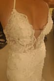 This dress is gorgeous!! I was so close to buying a dress I found in the store for $1k, but something told me to look on Lulus first. I randomly stumbled across this dress and for $300 (with the email sign-up discount) it's a steal! The quality is beautiful and it is the EXACT SAME DRESS I was going to pay $1,000 for in a shop. Fits true to size and is a little adjustable due to the strappy back. It does fit pretty long (I'm 5'5.5) so I'm probably going to hem it for my beach wedding, and I am usually an 8/10 in street sizes, and a size 10 fit like a glove!!! The ivory is still pretty true white, but not a bright white (if that makes sense), probably considered a very light light ivory or off-white. It was risky buying online, especially since there was only one review, but totally worth it. Buy this dress! - Liel C.