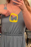 Bought this as a bridesmaid dress. I was torn between ordering a small or medium, ended up going with a medium and I'm glad I did. 
The back straps aren't adjustable, I don't think I have large/wide back/lats but the horizontal straps are a bit snug. 
The front is stitched oddly as pointed out in the picture. I plan to snip the one stitch to see how it lays naturally and resew if need be. 
Overall I'm happy with it! - Henry D.