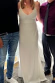 I wore this dress to be married by court. It arrived in a timely matter and I initially purchased it with the thought I may find something different, is it too simple, do I look horrible, etc. but I put it on and loved it. The back zipper needs assistance from a friend or your hubby. I have added a few photos. I did wear a shaper, no bra. - Kelsey C.