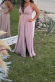 This dress is super nice the material does not look cheap it doesn't have any stretch. I usually wear small in Lulus dresses but on this one, I ordered a Medium - Isela V.