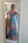 This dress is absolutely gorgeous in person. I am 5'5" 155lbs and got a Medium. I almost sized up to a large and I'm glad I didn't. It fits perfectly around the waist and flows beautifully to the floor. The top covers a good bit even with the low cut. I bought a low-cut backless/strapless bra to give my boobs a little push-up. My only complaint about this dress is the length. Again, I'm 5'5" and it is WAY too long, even with heels. I bought this dress to wear to a wedding this summer, and will also wear it on our beach vacation. I think it can be dressed up or down (flat sandals and a jean jacket). Overall, I would recommend this dress for sure - Stefanie C.