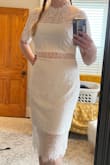 I really love the style of this dress, and the lace is beautiful. However I ordered a medium and a large and neither is right on me. I'm a solid size 8 jeans across most brands but carry my weight in the middle. The medium is so tight throughout the entire dress I couldn't lift my arms even up to shoulder height. The large is way more comfortable but manages to look too big especially up top. I'm going to play with some shapewear and see if I can get one to work, though, I love the dress so much.

Note, the lace pattern is gorgeous but also isn't uniform so the top might look different from the picture. The large I got has the vertical part of the pattern at the top of the dress (see photos). - Erin W.