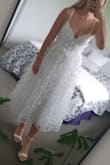 I love this dress! Bought for my wedding reception! Fits perfectly and I'm a standard size small. The dress is a little see through but just need to wear neutral underneath and it's fine! Would definitely recommend this dress!! - Shania S.