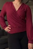 Love the fit and look of this shirt, the material is so soft and the color is so flattering with deep winter skintone. I had to take a star away as the material pills quite a bit after washing and hang drying. Also be cautious with the surplice, if I wear it to work I pin it as there isnt a snap to keep it closed and have had a couple near-misses with my bra showing going out in it. - Carley J.