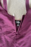 I took it out of the packaging and before trying it on, I noticed the center was ripped. The wire is poking out the top and bottom seams. - Kate U.