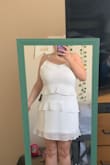 I like this dress. It's actually pretty comfortable because it's not super form fitting or tight. Straps are adjustable which is a nice touch. Ruffles are placed to cover the tummy is you're self conscious about that. Not see through at all which is nice too! - Olivia M.