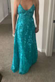 The color is darker than how it looks online. More of a teal color than a blue. It's really pretty but because the back is adjustable with the straps I could have probably gotten a S but I wore the M and was able to adjust it just fine. The fabric is super pretty. Not very much support in the boob area and no padding. - Sierra J.