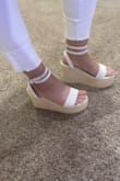 These wedges are great, they are tall but sturdy, I don't feel like I'm going to break an ankle. The front strap is a little tight but I think after a couple wears it should give and break in. These can easily be worn with anything from dresses to shorts. - Whitney F.