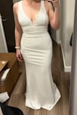Bought this dress for my wedding. I love this dress! It's so simple and so gorgeous. The neckline is so pretty and it is stabilized with an insert along the seam so there is a lot of support to hold you in and keep the shape of the dress in the chest area. I was looking for a v-neck gown for so long and finally found this one. It's an incredible dress. - Ashley K.