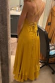 I'm usually not into ruffles or satin fabric, but I tried this on and knew I had to have it! The back is so flattering, and the dress is comfortable and flowy and will make you want to dance! It's an eye-catcher and bound to get you compliments. You'll probably need some help tightening the ties in the back, and the left chest area did tend to flip over to reveal the lining, but I was able to fix that with some fashion tape. - Anita D.