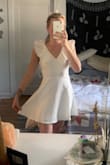 I'm usually a size 4 in dresses - I bought the small and medium and the small fit perfectly. But there is zero stretch so if you're in-between sizes and have any bust at all I'd size up. Not too short and the fabric is nice and thick. Perfect little cocktail dress! - McKenna D.