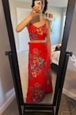The back of the top is a lace up affair that allows a lot of fluctuation in sizing, but the top itself is poorly stitched as you can tell by the weird puckering along the bottom hem in my photo that spot where it's pulling up is permanently messed up from the bad stitching. The skirt was WAY too long. I'm 5'8" and it would need to be hemmed at least four inches to be wearable. - Jordan F.