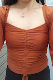 It's super cute but pretty tight! The fit finder recommended S so I got that, but after wearing it, I would have liked to go up a size. I'm kind of concerned about the center seam ripping because it's thread-only and my chest is wide so I'm stretching it a lot (you can see my skin under the seam-see photo). I'm worried if it rips, it'll be too hard for me to fix myself! - Gabrielle