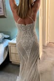 Such a simple elegant well made gown.  Light beige underlay was perfect for my 2nd wedding.  I did have to have length hemmed, was very long for me even with heels on.  Only complaint was straps.  Thin cheap ribbon like material,  and tricky to get into since they are crisscrossed in the back and don't come off & have to step into them over your head with arms going thru straps in the right position.   Straps are adjustable,  but you have to be very careful when adjusting the material flips and then it's twisted. You have to make straps as long as they can to get on, and then adjust to fit. If i had the time and thought of it earlier I would have had straps replaced when altering ( made to come off to make easier to get on ) Other than that super comfortable,  wore for 6+ hrs .  Wore body shaper under that couldn't be seen at all, beading was so intricate and classy for such an affordable gown.  Ordered a medium and large, medium was perfect for me.  Return process was simple and fast refund. - Erica C.