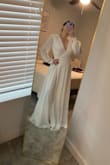 I like this dress. It is very relaxed and romantic, it has a good fit for the body, and the cross-body lace makes it easy to adjust. 

It is kind of heavy and long, but it is perfect for a small wedding. - Danielle F.