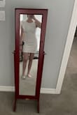 I ordered this for my graduation and I love it! It is a little short for my height, so I'll either have to avoid bending over or I will just squat to get something from the ground. The material is nice but has very little stretch to it. It is a little bit see-through, so wearing nude colors underneath is super important! Overall, this has a flattering fit to it and looks classy with the flare on one sleeve! - Megan M.