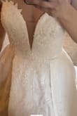 While I didn't keep this dress, I did love it! The material is great, the dress is heavy!!! 6ish lbs! The slit is very high and adds a lot of sex appeal to the dress if that's what you're looking for! Personally, I loved it! Dress is LONG, so if you're under 5'6 it'll need to be hemmed A LOT!
I'm usually a size 2-4 in princess/ball gowns, the 6 fit perfectly. Definitely size up 1-2 sizes! I imagine the 10 would fit like a 6.
However, after trying on other dresses this just was not my dress! I found many others I loved more! - Lauren C.