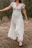 Bought this dress for my wedding vow renewal. It fits true to size. The material is soft but wrinkles easily. Super comfy and flattering! The only thing I didn't like is that the zipper was difficult to zip up and I felt like it could have been a tad longer. Overall it's a pretty dress! I got lots of compliments. - Jessica G.