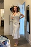 I was looking for a white, true "midi" dress for my upcoming college graduation and I think this dress has taken the cake! I went with my suggested size, small, and it fits perfectly, however, I will have to explore a bit on the no bra situation (I am a 32D, and while the dress has breast cut outs mine seem to disagree on this placement). I will say it does run a bit long as a shorter girl but honestly with heels I think it will look great. Also love that it is not super tight in the tummy area and if you have a bit of a belly you would still have room in a small! - Katelyn H.