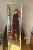 I tried both the large and medium. Both fit me, just in different ways. The medium hugged my body more and the large is a bit more loose in an elegant way. I ended up going with the large so I can use it for more formal events (ie a wedding). If I wanted to wear it more casually, I might've gone with the medium. As a tall person, it can be so hard to find something that is long enough and I love that the pant legs go all of the way to the floor. - Jennifer M.