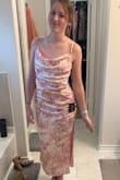 The dress is very soft, feels like satin. It's so pretty and a little more pink than pictured. So great for graduations/weddings or a nice date! - Ashley L.