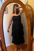 I ordered this in a medium and had to exchange it for a large. The bust area was so tight even with the elastic back. I am keeping the dress in large for those parties that need a more elegant attire. Beautiful dark blue - Catherine S.