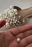 Just got the shoes in and I didn't even wear the shoes and the pearls are already falling off of the shoes. Terribly disappointed and the shoe runs small. I usually wear at 7.5 but will need a size 8.beautiful shoes but I wouldn't recommend buy it due to the pearls are falling off both shoes - Lucy T.