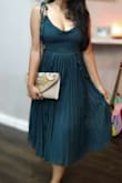 The dress was exactly as pictured. Flowy, gorgeous colour and comfortable. It does take some effort to zip up and there is some (side boob) cleavage present. This was me trying on the dress so top undergarments were yet to be figured out. Very happy with my purchase (clutch was also from Lulus). - Sharmila D.