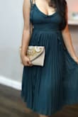Really happy with my purchase. The clutch is well made and dresses everything up. The strap inside is another option in case you want to be hands free. - Sharmila D.