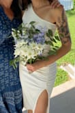 Wore this to my courthouse wedding at it was perfect! It's classy and elegant but also has a beachy vibe to it. The neckline and length were modest but the one-shoulder and thigh slit gave it a little something extra. The material was tight and comparable to spandex, but it wasn't so tight I couldn't breathe. The ruching on the sides also made my waist look very good. I loved this dress and can't wait to rewear it for more wedding events in the future!! - Erika B.