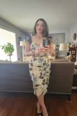 I ordered this dress for a family wedding. It is a beautiful dress. Great quality material and very detailed. The leaves look black but they are actually dark green sequin. I received many compliments at the party. It fits like a glove. The liner is a bit sheer. Be careful with what you wear underneath. The only complaint I have is that the dress would shift on me. The zipper and split would wind up moving to the side. Not sure if it was because I was wearing Spanx underneath and that caused it to move. Loved the dress. Will definitely wear again without the Spanx. - JEANNETTE M.