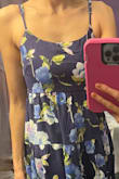 I loved the dress. It has adjustable straps and thick fabric, but the fabric is not thick enough to make you look frumpy, fat, or just unflattering looking. It looks expensive. I am usually a size xs-s, most times I go for the small but this time, the dress seems "a little" on the bigger side. I think I could've gone for an XS but I still kept it bc the extra space doesn't bother me. It's comfortable. Also, I tied the straps tight enough to make it work... overall I recommend it but if you are between sizes, choose the smaller one. I don't think I would recommend this dress for shorter people. I am 5'8 and it hits me right on the midcalf. It looks super cute with heels! <3 - Ana M.