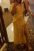 Bought this for a wedding and wow I love this dress sm!! I'm pretty short so this turned out to be more of a maxi dress but that's exactly what I wanted and the slit still came at a perfect height. I could have possibly fit into a small but I did choose an xs and it wasn't too tight on me. I did use fashion tape for the bust part and it was fine. The dress is flowy and so fun to dance in! Got lots of compliments too. Never owned a yellow dress either and loved the color. :) - Robyn M.