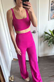Really liked this very bright fuchsia outfit. Wore it to Coachella. 

I normally have trouble with sets because I am larger on the bottom than top, but the material was stretchy enough that the size S fits well. This top fit more like a bra top than a crop top on me, so fyi that you will have a good amount of midriff exposed if you have larger boobs. I also thought I might need to hem the pants, but they were fine with some 1.5-inch boots and I am only 5'6. I think it depends on how high-waisted you want to pull up the pants. - Susan J.
