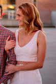 I bought this, and the matching pants, for one of my outfits for my engagement shoot. It fit well and was super comfortable. I didn't wear a bra but I did add in a small cutlet (they're a little uneven) into one side and it stayed the whole time. It's definitely looser on me than on the model so if you're smaller than I am, the XS might be too big for you. - Cady W.