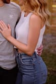 I really liked this top and wore it for some more casual engagement photos. It fits loose and seems shorter on me than it is on the model. I wore a nude bra under for photos and didn't have any issues. I'm sure if you really looked at it you could tell though. - Cady W.
