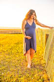 I ordered my prepregnancy size and it looked amazing. The feel of the fabric is so soft and the dress flows wonderfully. I can't wait to see how it looks after baby comes! It's definitely become my go-to dress for events. - Jessica M.