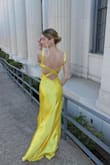 My daughter felt beautiful in this dress! It fit her perfectly, and she received many compliments. It doesn't photograph well with flash, so I think a softer yellow and less shiny fabric would be better. A show-stopper for sure though! - Julie L.
