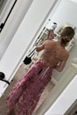 I fell in love with the back of this dress! So flirty and fun!! Unfortunately, my dress came ripped. Sad. The material was also kind of itchy on my skin. Also, I have a small chest and no matter how tight I had the back I couldn't get the top part tight enough to actually cover my boobs without exposing myself or giving a clear view of the sticky boobs. So very pretty but not for me. - Ashley M.