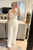 Love this top with the matching pants! Fits great and feels supported without wearing a bra. It fits perfectly on me but if I gained 5lbs it would probably be too tight to be comfortable. I would not want to size up though because the Large would be too much fabric in the chest for me! Fabric and construction are great! Plan on wearing it to my casual rehearsal dinner. - Madeline L.