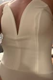 It has a weird ribbon-like lining that you can see through it. It goes right along the seam down your boobs and looks so strange. Fits, but flimsier than expected. Boning also doesn't sit flat against the chest - Emily F.