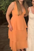 I wore this dress to a beach wedding and it was beautiful but was tight in places and loose in others on my body. It was very tight on the rib cage. I was able to zip it but at first, was worried about the seam ripping, but it held up through lots of dancing and didn't rip or stretch. The chest area was not structured and was a little too open for my liking. I had to use boob tape to separate and hold the girls in place so they wouldn't spill out the middle. Can't really wear a bra with how open the top is. Still beautiful, but I was a little self-conscious about the top around family members. - Dakota B.