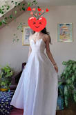When I first opened the package I needed to fidget with the fabric on the neckline of the dress because it was sort of twisted around the wire in the deep V. But once I got it to lay right, it looked just like the photos on the website. As a girl on the taller side who plans to wear this with very short heels, the length is perfect too. Can't wait to wear this as my reception dress! - Caitlin F.