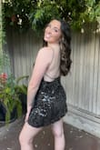 The dress was very cute! Definitely don't size down if you are taller because the dress is a bit short. A medium was long enough for my height. Very cute and easy to wear, received lots of compliments! - Sierra E.